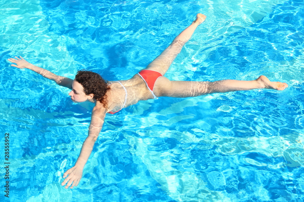 woman wearing swimming suit is swimming in swimming pool woman wearing swimming suit is swimming in swimming pool