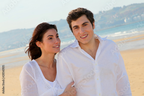 Portrait of lovely couple walking on the beach
