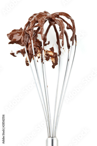 Metal whisk with chocolate isolated on white