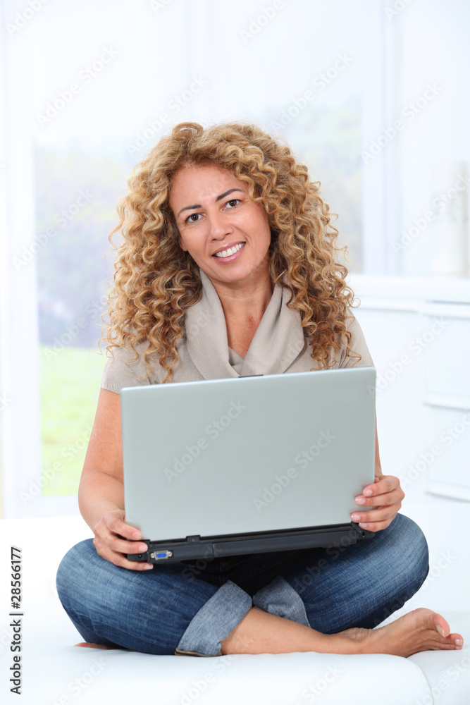 Woman at home using laptop computer Woman at home using laptop computer