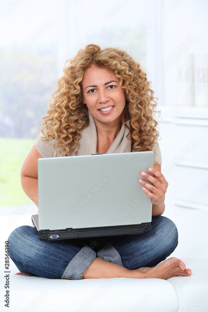 Woman at home using laptop computer Woman at home using laptop computer