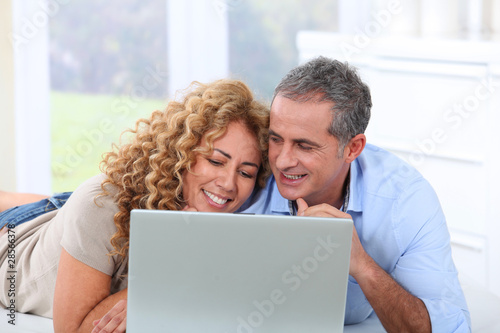 Couple surfing on internet at home