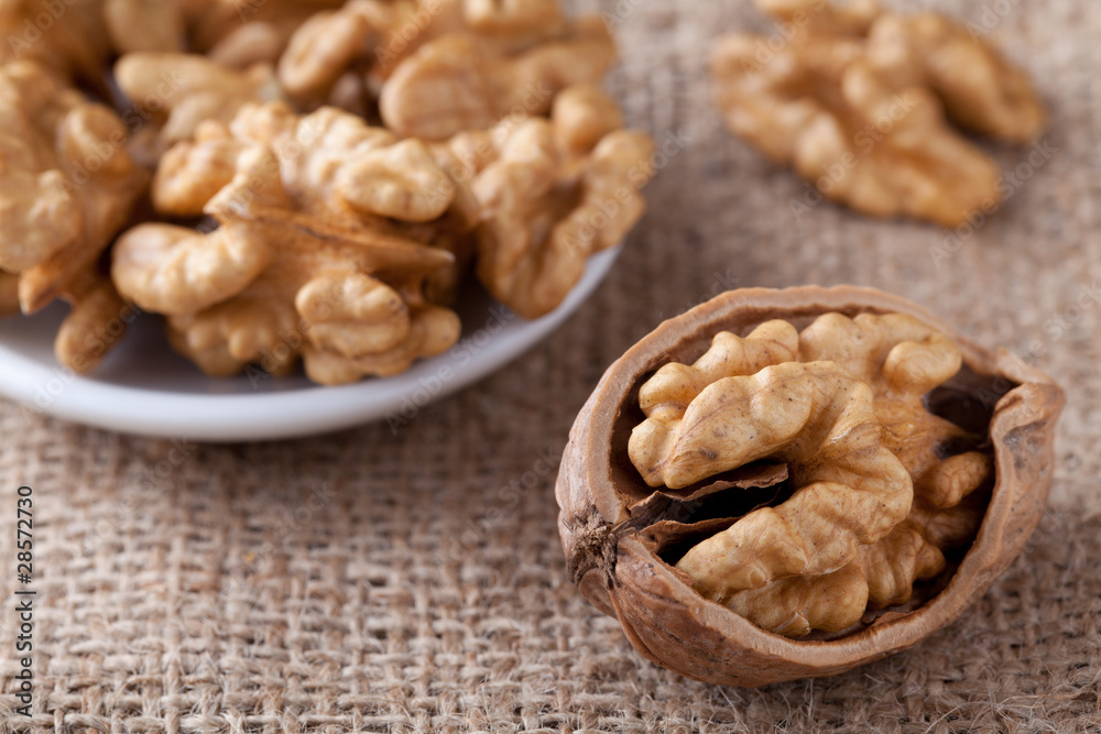 Kernels of nuts in plate and Circassian walnut on sackcloth Kernels of nuts in plate and Circassian walnut on sackcloth