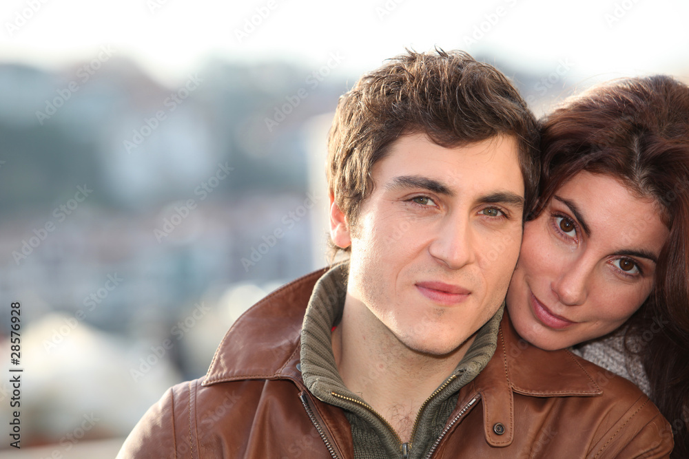 Portrait of young smiling couple in town