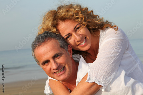 Portrait of happy mature couple at the beach