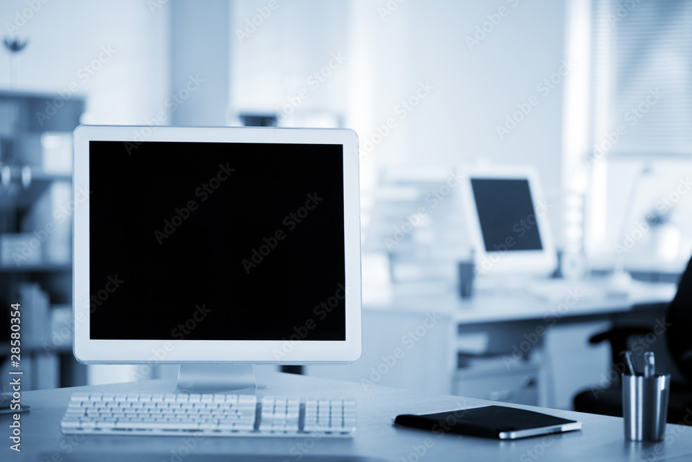 Computer and notebook on the working place in the office Computer and notebook on the working place in the office