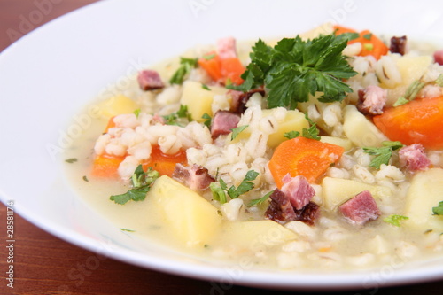 Barley soup on a wooden background