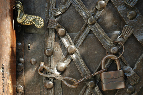 Iron padlock and chain on old door