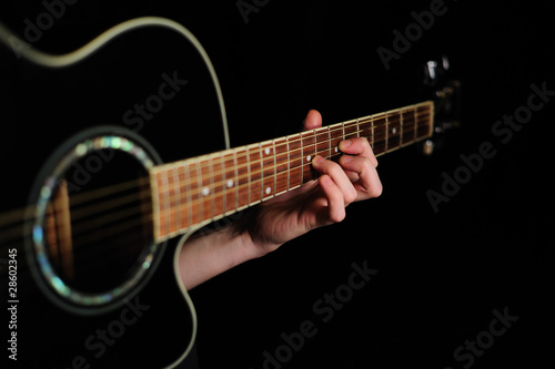 Man's hand striking a chord