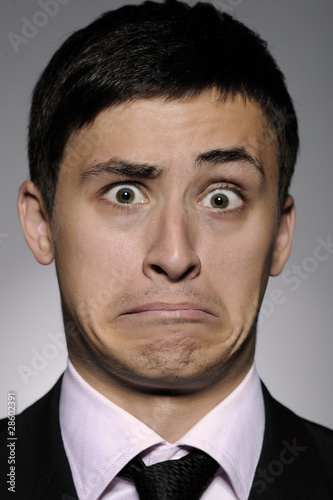 Portrait of stressed business man in formal suit and black tie h