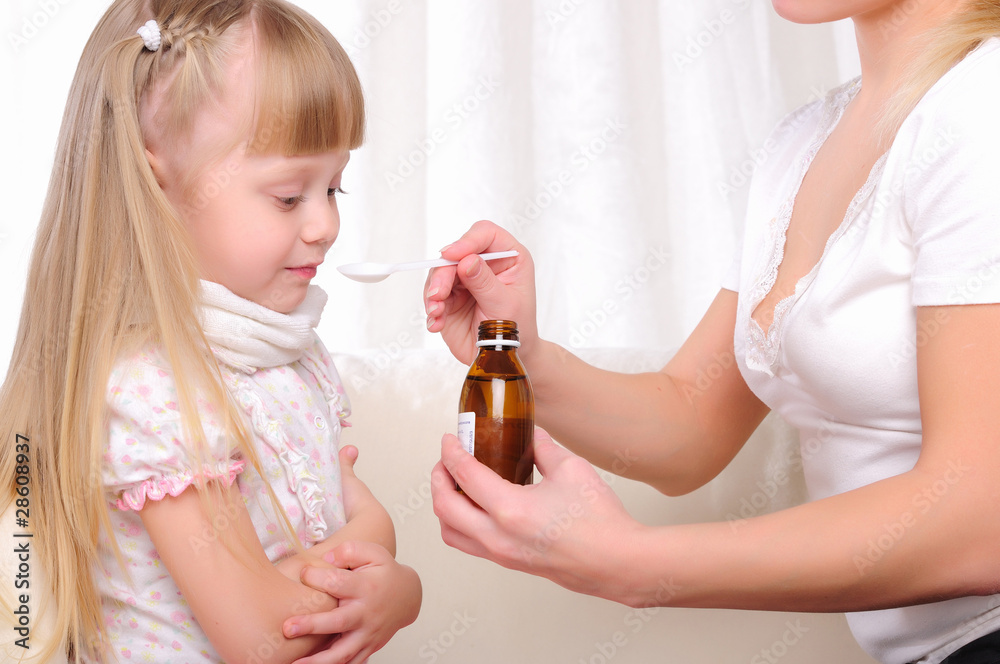 Fototapeta premium Little girl drinking cough syrup