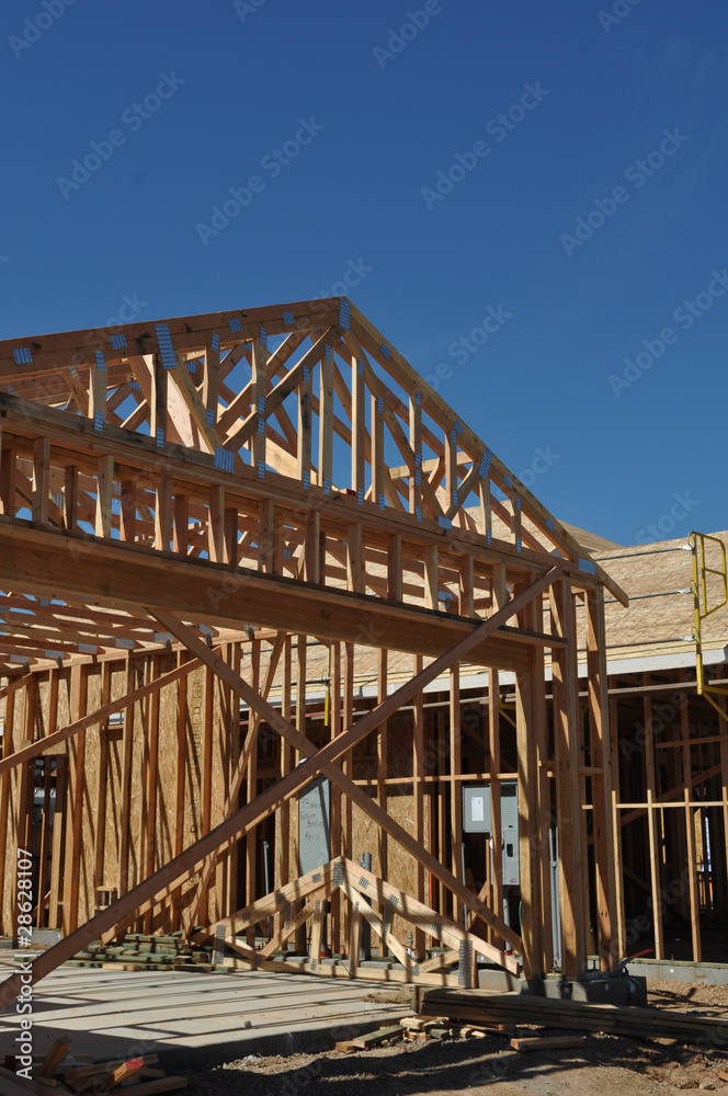 Fototapeta premium New Home Under Construction with Boards Foreground