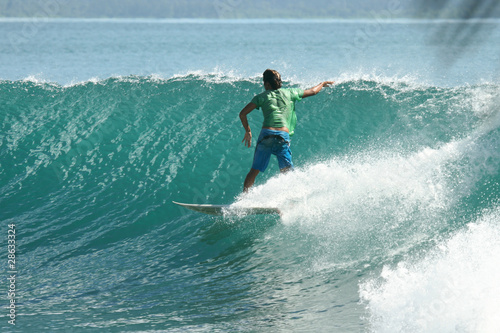 Surfer on perfect green wave