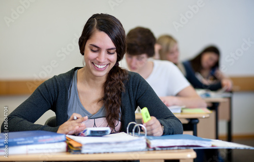 Student working on homework in classroom