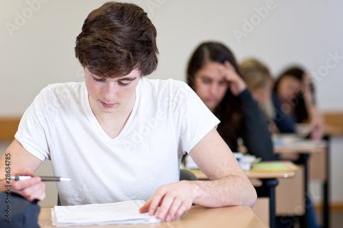 Student working on homework in classroom