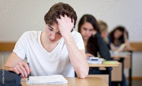 Student working on homework in classroom