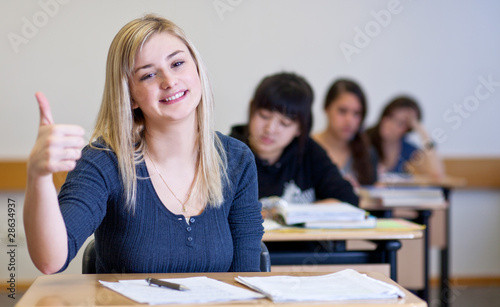 Happy Student has fun while working in classroom