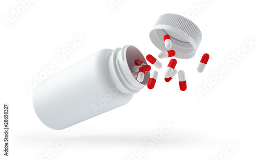 Droped white bottle with pills