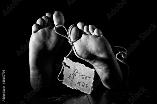 фотографія Death. Feet of a corpse on a wooden floor with cardboard