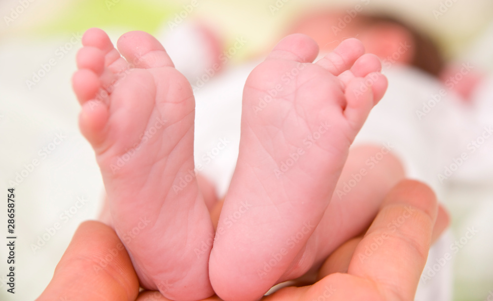 Newborn Baby`s feet in Daddy`s hand Newborn Baby`s feet in Daddy`s hand