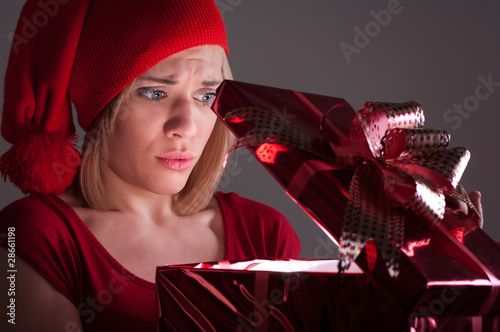smiling girl opens a gift