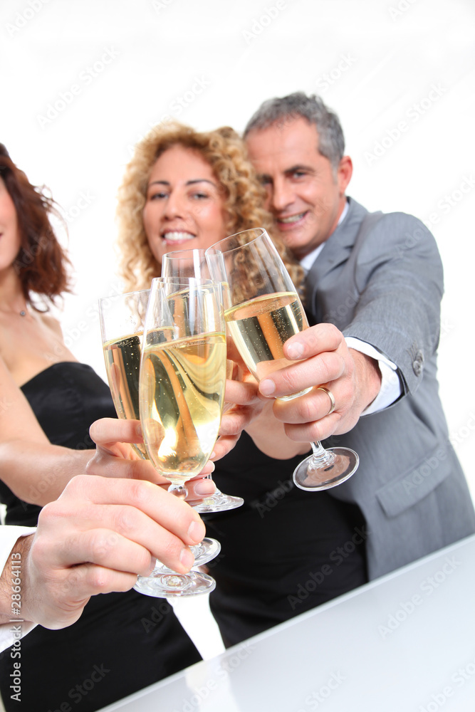 Group of friends cheering with glasses of champagne Group of friends cheering with glasses of champagne