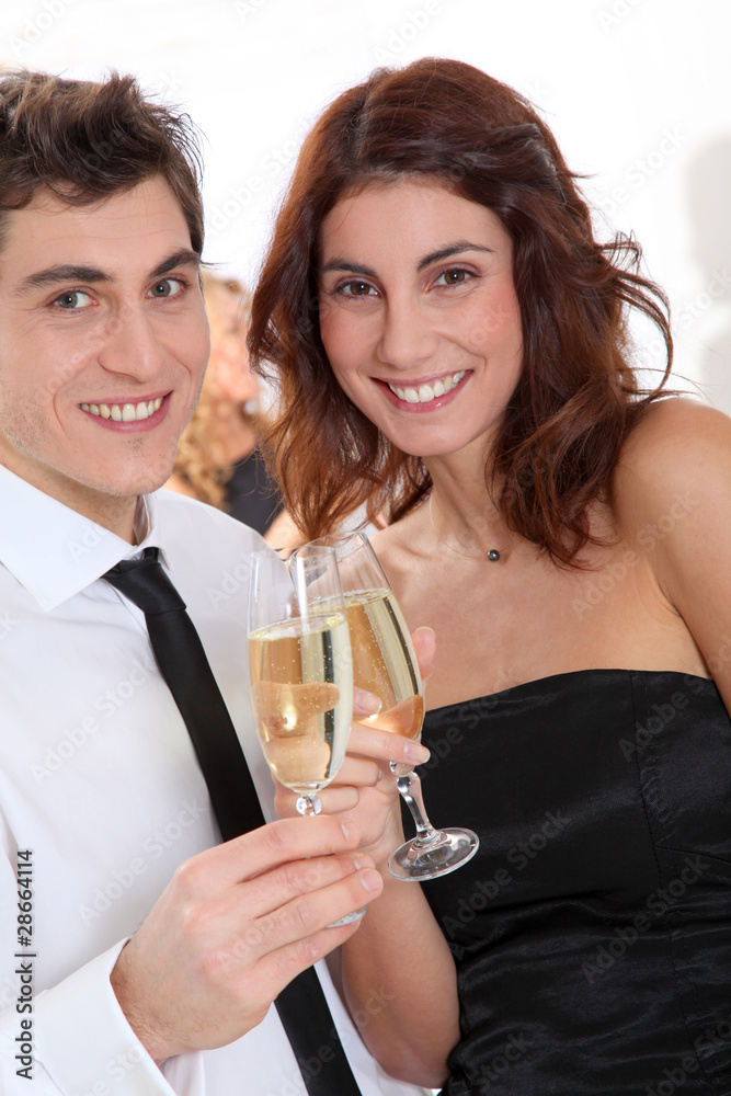 Couple celebrating new year's eve with champagne Couple celebrating new year's eve with champagne