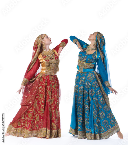 Two young women dance in indian costume