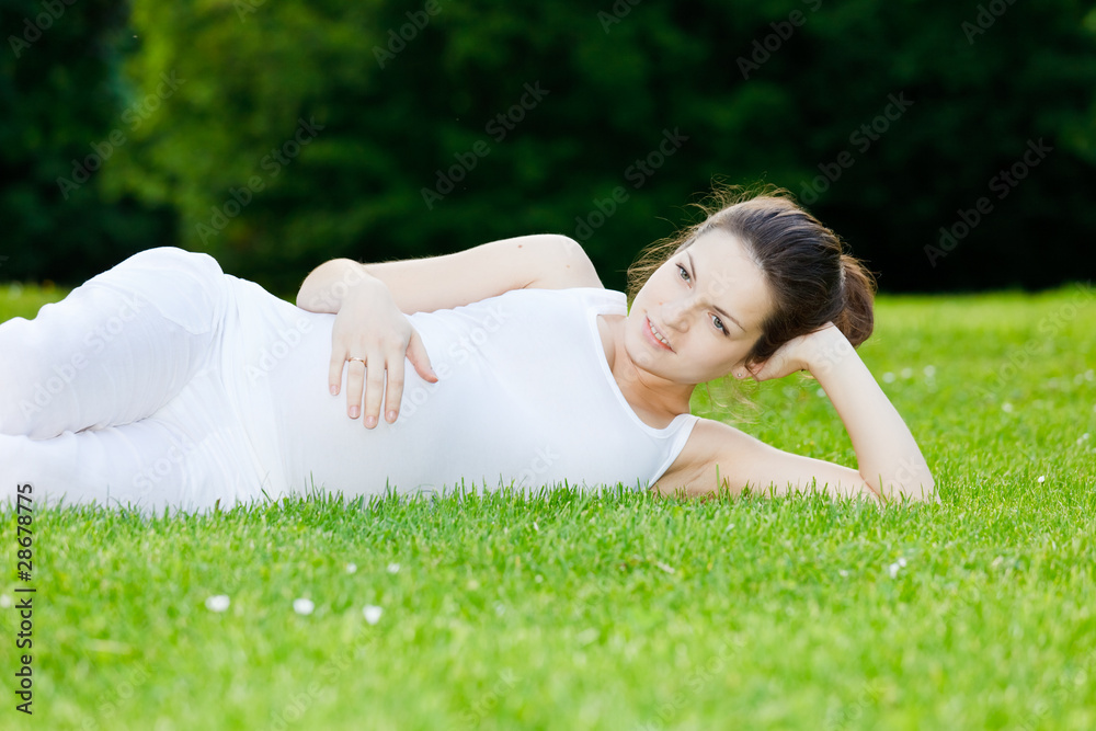 Beautiful pregnant woman relaxing in the park Beautiful pregnant woman relaxing in the park