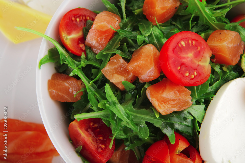 salad with smoked salmon in white bowl