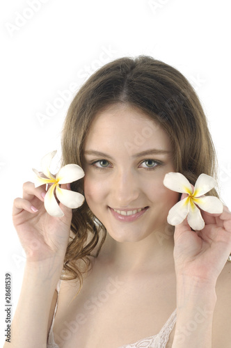 close up young woman holding frangipani flower