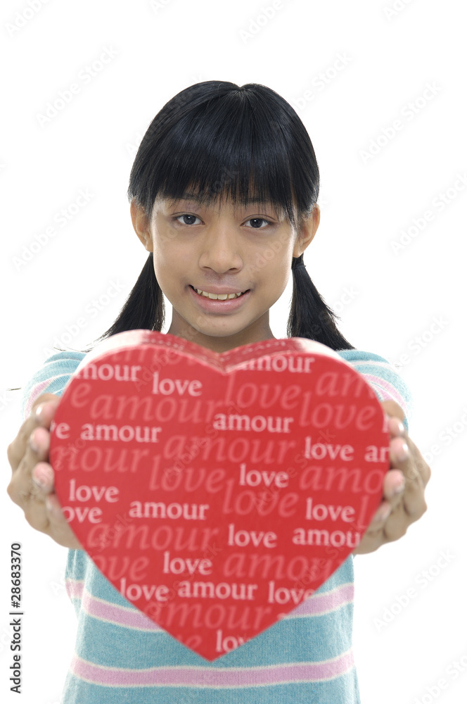 Portrait of young girl holding heart gift isolated on white Portrait of young girl holding heart gift isolated on white