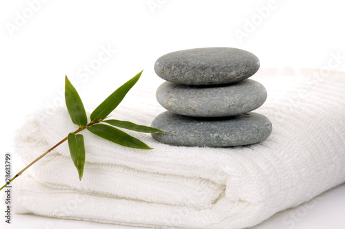 Zen stones with bamboo leaf on towel