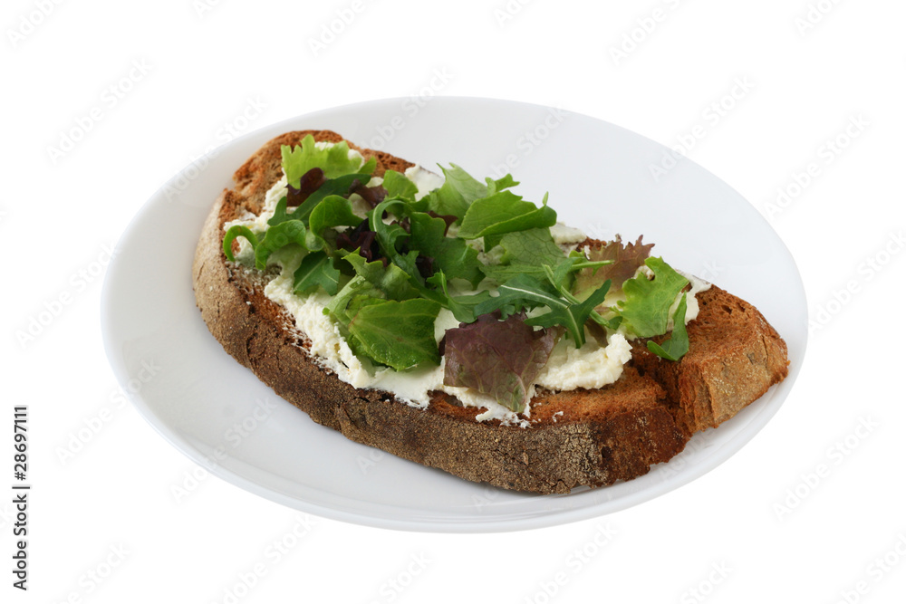 bread with cream cheese and salad on a plate