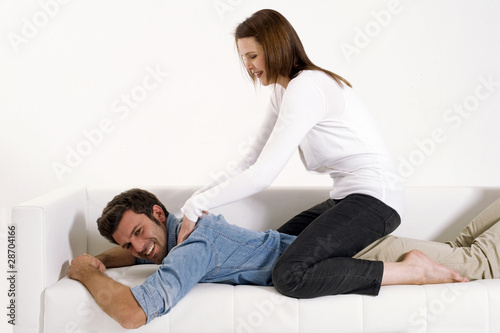 woman massaging the shoulders of man