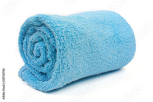 rolled up blue beach towel on white background