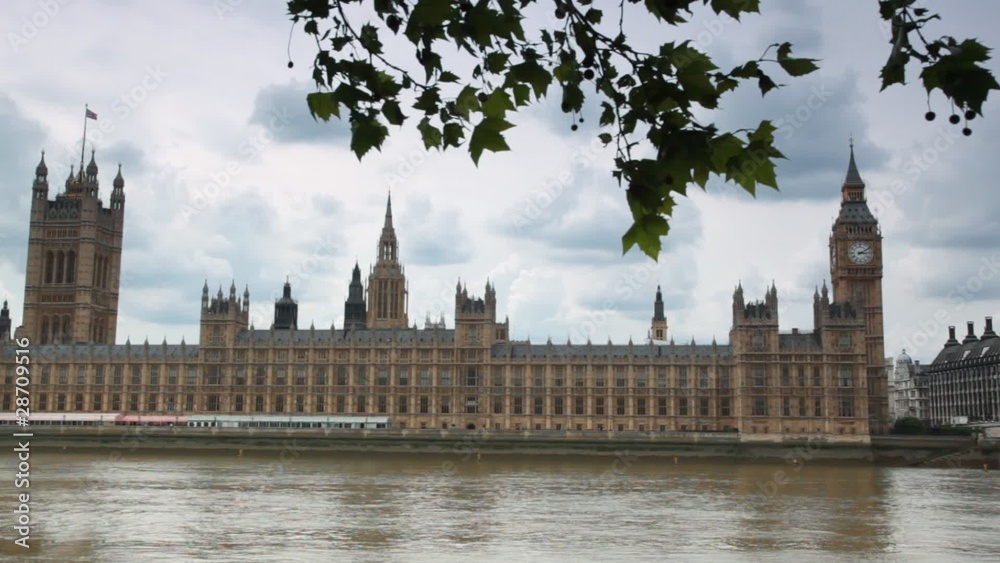 Houses of Parliament and Big Ben behind Thames river Houses of Parliament and Big Ben behind Thames river