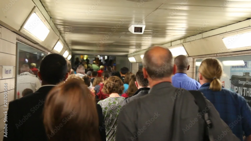 Very many people are going in metro past each or Very many people are going in metro past each or