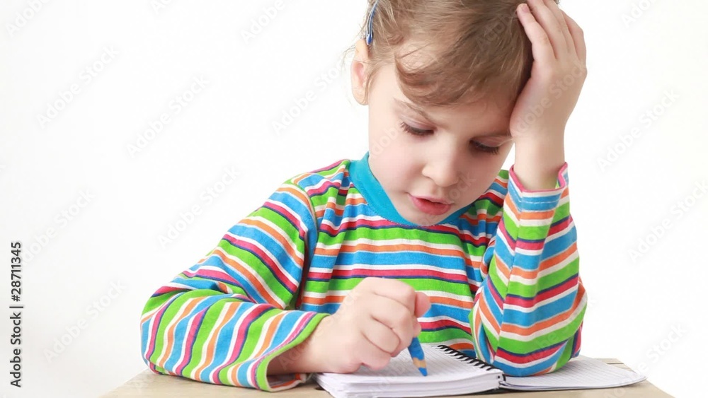 puzzled girl sitting at table with pencil and notebook puzzled girl sitting at table with pencil and notebook