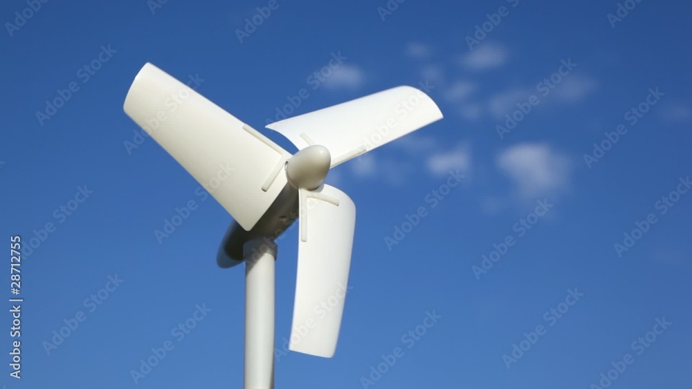 tiny wind driven generator rotating against sky tiny wind driven generator rotating against sky
