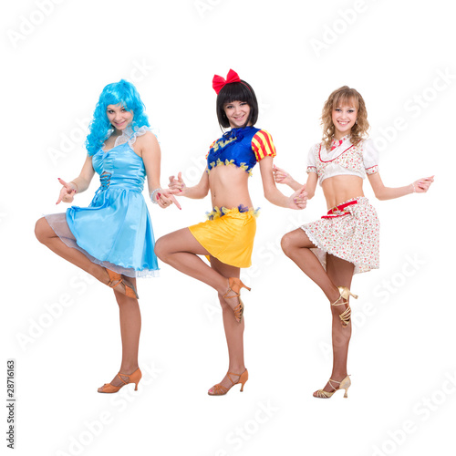 Three smiling girls dancing