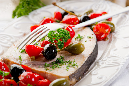 swordfish with tomatoes capers and olive photo