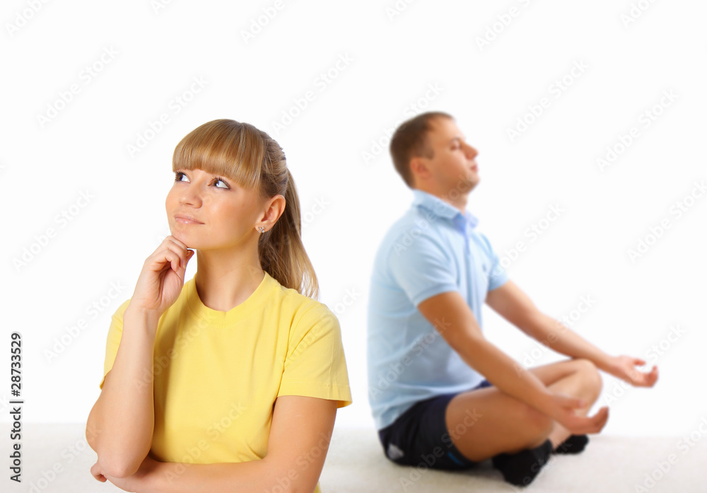 Young woman and man doing yoga in background. Young woman and man doing yoga in background.