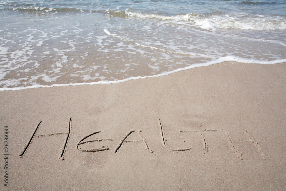 Fototapeta premium Health, written on the sand