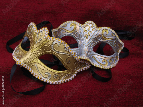 Two masquerade mask on red cusion