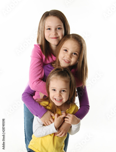 Three young sisters having fun
