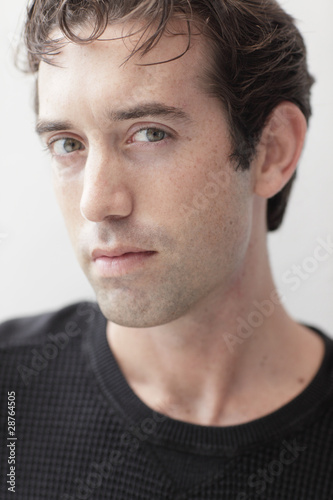Headshot of a handsome man in a black shirt