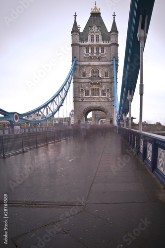 Unusual view of Tower Bridge in London with blurred pedestrians