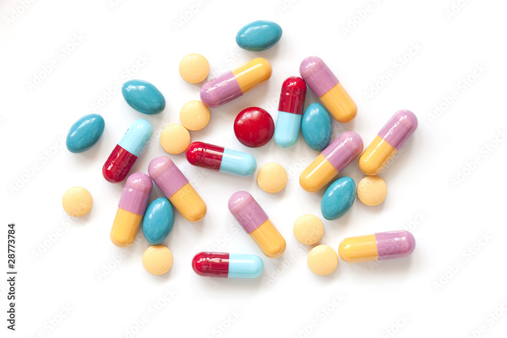 Colorful pill tablets on white background