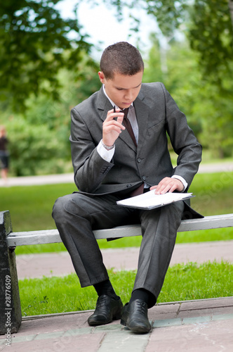 business man working with papers at park. Student © mr.markin